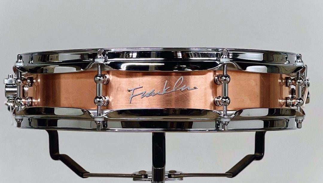 The Franklin Copper Snare drum in 3x14 with a walled shell, natural patina finish, and tube lugs.